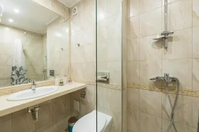 a bathroom with a shower and a toilet and a sink at Blue Horizon Suite in Varna City