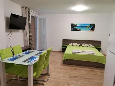 a small room with a bed and a table and chairs at Path ways to the Sea -Пътека към морето in Primorsko
