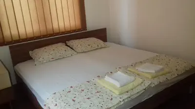 a bed with two pillows on top of it at Guest House Nedelchevi in Primorsko