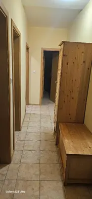 an empty room with a hallway with a wooden closet at Apartament Prestig Sity in Sunny Beach