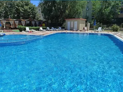 a large swimming pool with blue water at Apartament Prestig Sity in Sunny Beach
