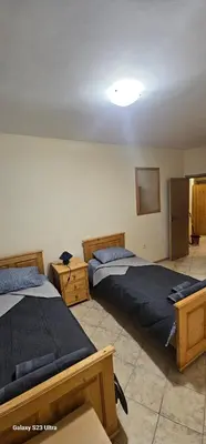 a bedroom with two beds and a light on the ceiling at Apartament Prestig Sity in Sunny Beach