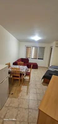 a living room with a table and a couch at Apartament Prestig Sity in Sunny Beach