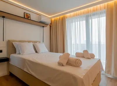 a hotel room with a bed with towels on it at ВХТИ Park - Premium Apartment in Burgas City