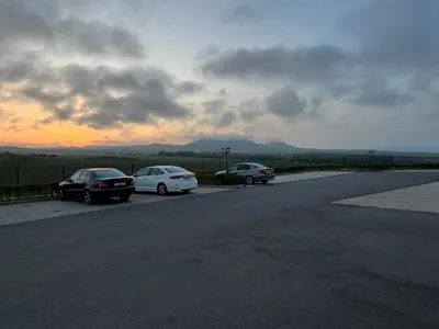 three cars parked on the side of a road at Family Apartment with Sea View Vineyard Spa Resort Aheloy in Aheloy