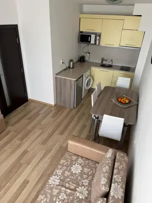 a small apartment with a table and a kitchen at Sea View Apartment Sveti Vlas 1 Bedroom K&R in Sveti Vlas