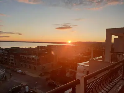 a view of the sunset from the balcony of a building at Sea View Apartment Sveti Vlas 1 Bedroom K&R in Sveti Vlas