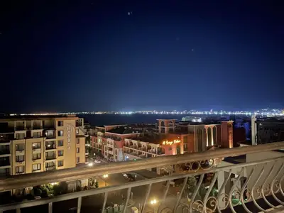 a view of a city at night from a balcony at Sea View Apartment Sveti Vlas 1 Bedroom K&R in Sveti Vlas