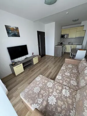 a living room with a couch and a flat screen tv at Sea View Apartment Sveti Vlas 1 Bedroom K&R in Sveti Vlas