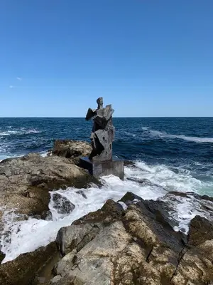 a statue on the rocks by the ocean at Art Complex Anel in Sozopol