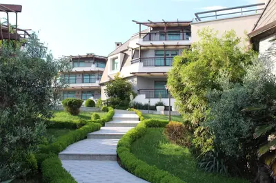 a garden with a walkway in front of a building at Art Complex Anel in Sozopol