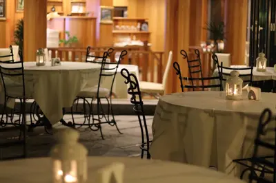 a room with tables and chairs with white table cloth at Art Complex Anel in Sozopol