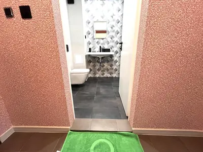 a bathroom with a toilet and a green floor at Miramar Front Beach Family Deluxe Studios No Swim Pool Access in Sunny Beach