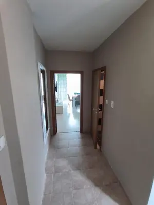 an empty room with a hallway with a door to a living room at complex Sol Marine sunny beach in Sunny Beach