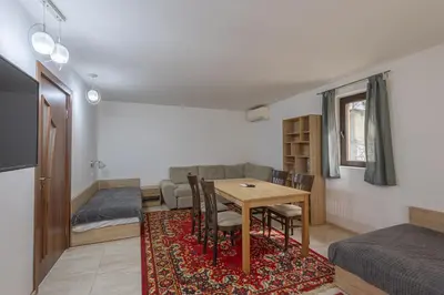a small room with a table and a couch and a bed at Sea Garden Marina 1 Apartment Varna in Varna City