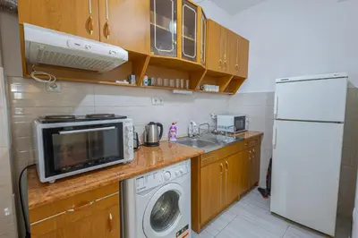 a kitchen with a washing machine and a refrigerator at Sea Garden Marina 1 Apartment Varna in Varna City