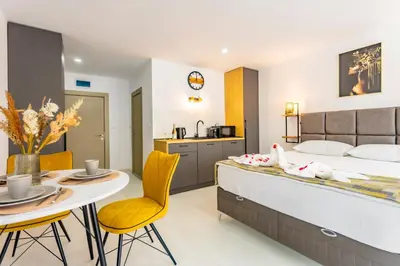a bedroom with a bed and a table and chairs at J'ADORE Secret Garden A&K Deluxe Studio in Sunny Beach