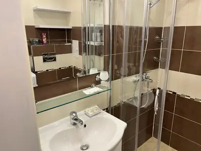 a bathroom with a sink and a shower at Сарафово холидейс in Burgas City