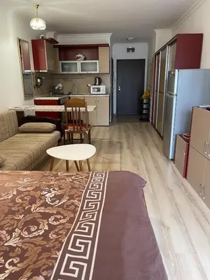 a living room and kitchen with a couch and a table at Amphora studio 209 in Sveti Vlas