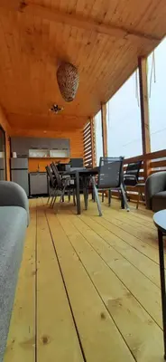 a dining room with a table and chairs in a room at Бунгало Шангри Ла - 1, плаж Градина in Sozopol