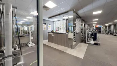 a large room with a gym with machines at Flores Garden Pool Side and Sea View Apartment in Chernomorets