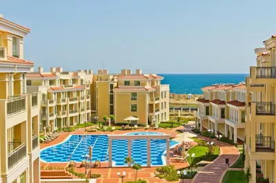 an aerial view of a resort with a swimming pool at Flores Garden Pool Side and Sea View Apartment in Chernomorets