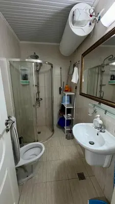 a bathroom with a shower and a toilet and a sink at Слънчево Море in Nesebar