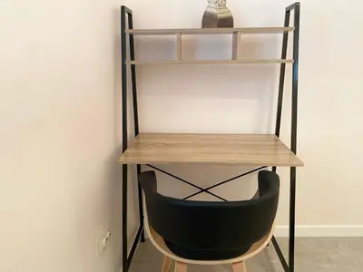 a shelf with a black chair under a desk at New Yorker 2 bedroom apartment in Varna City
