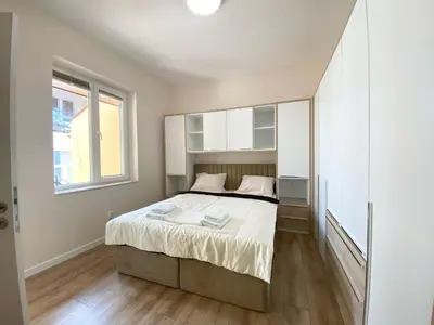a bedroom with a bed and a large window at New Yorker 2 bedroom apartment in Varna City