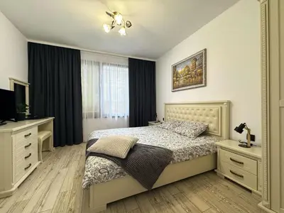 a bedroom with a bed and a television in it at Przytulny apartament w Sweti Vlas 350m od morza in Burgas City