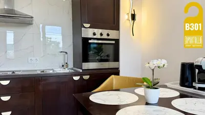 a kitchen with a table with two plates on it at ROYAL BEACH - Private Apartments - Center of Sunny Beach in Sunny Beach