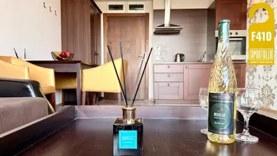 a bottle of wine and glasses on a table at ROYAL BEACH - Private Apartments - Center of Sunny Beach in Sunny Beach