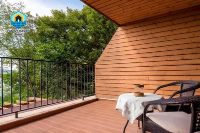 a patio with a table and chairs on a deck at Вилла Biala family haven in Byala
