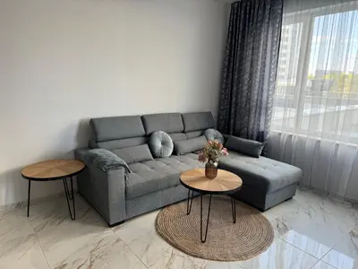 a living room with a couch and two tables at Central Park 7 in Burgas City