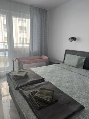 a bedroom with two beds with towels on them at Central Park 7 in Burgas City