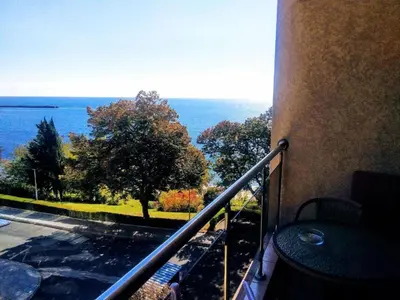a balcony of a building with a view of the ocean at Vigo apartment in Nesebar