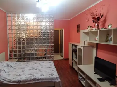 a bedroom with pink walls and a large glass wall at Vigo apartment in Nesebar