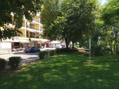 a green lawn in front of a building at Vigo apartment in Nesebar