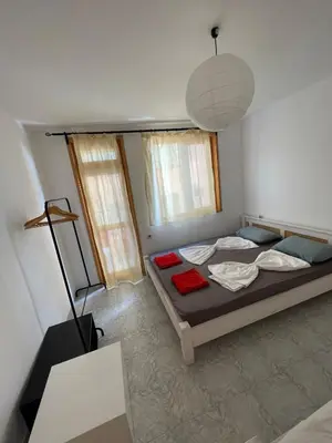 a bedroom with a bed and a lamp in it at Bonne Chance Apartment Sozopol in Sozopol