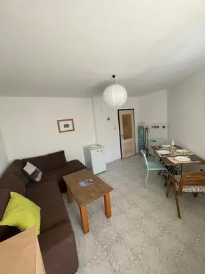 a living room with a couch and a table at Bonne Chance Apartment Sozopol in Sozopol