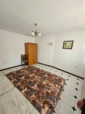 a bedroom with a bed with a blanket on the floor at Lazur Family Apartment Pomorie in Pomorie