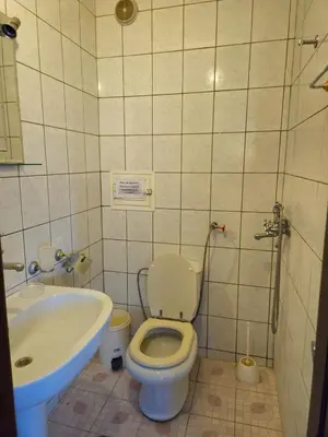 a bathroom with a toilet and a sink at Lazur Family Apartment Pomorie in Pomorie