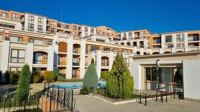 a large building with a pool in front of it at Golden Lady in Sveti Vlas