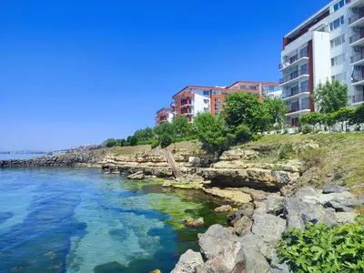 a body of water next to some buildings at Golden Lady in Sveti Vlas