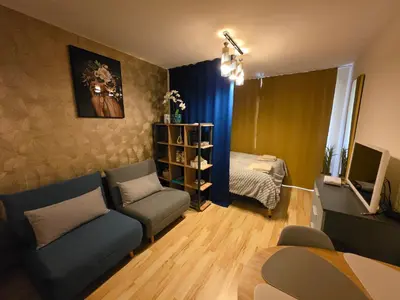 a living room with a couch and a bed at Golden Lady in Sveti Vlas