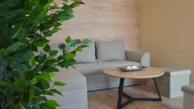 a living room with a couch and a table at Апартаменти Bella Deluxe in Ravda