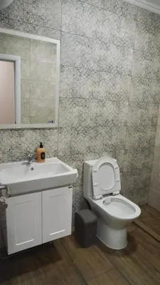 a bathroom with a sink and a toilet and a mirror at Апартаменти Bella Deluxe in Ravda