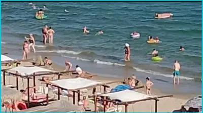 a group of people swimming in the water at the beach at ETARA - 1 Rey&Mar Saint Vlas in Sveti Vlas