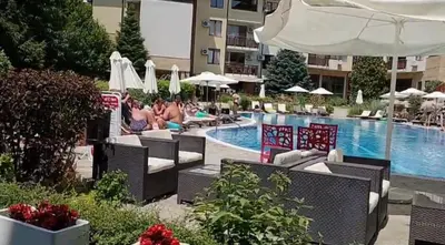 a pool with chairs and umbrellas in a hotel at Garden of Eden- Apartments Sweet Dreams Rey&Mar Saint Vlas in Sveti Vlas