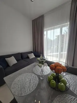 a living room with a table with fruit on it at Grand Villa Deluxe Apart in Sveti Vlas